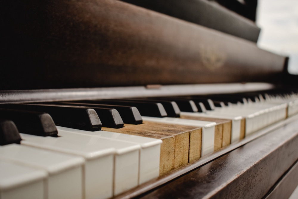 Worn keys on an old upright piano ready for disposal